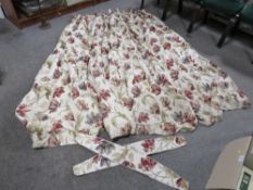 A large pair of Laura Ashley floral curtains with tie backs