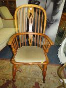 A light oak Windsor style arm chair