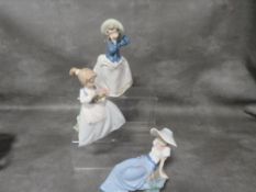 Three assorted Nao figurines