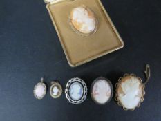 A small box of yellow and white metal mounted cameo brooches and pendants