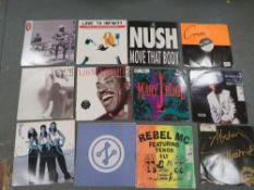 A tray of assorted LP records to include EMF, Rebel MC etc