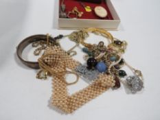 A quantity of assorted costume jewellery to include an engraved hallmarked silver clasp bangle