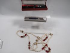 An assortment of costume jewellery and pens etc