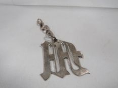 A hallmarked silver pendant in the form of letter M approx weight 24.5g