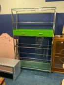 A modern chrome bookcase with glass shelves