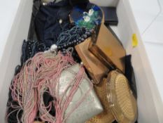 A tray of assorted vintage compacts, jewellery bags etc