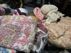 A quantity of fabrics, vintage quilts etc