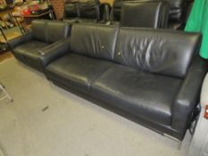 A two piece black leather suite, comprising a two seater and a three seater settee