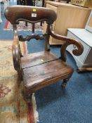 A reproduction antique style child's wooden armchair