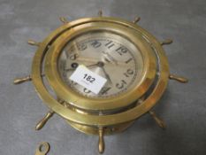 An eight day brass ships bell clock with key