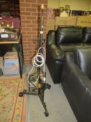 A vintage cast iron gas lamp standard with electric conversion