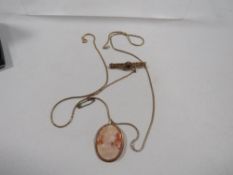 A cameo pendant brooch with yellow metal mount stamped 9k on gold plated chain together with a