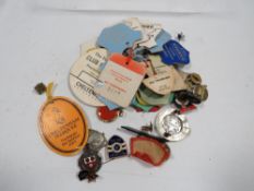 A bag of collectable enamel and other badges together with horse race course tags etc