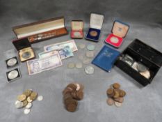 A tray of vintage coins, notes and collectables