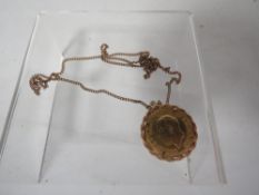 A George V South African mint sovereign pendant dated 1929 on a 9ct chain approx combined weight