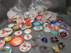 A collection of vintage and modern badges and various slammer whammers