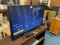 A Sony 32” flatscreen television with remote - House Clearance, together with a radio