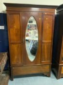 An antique mahogany inlaid mirrored wardrobe