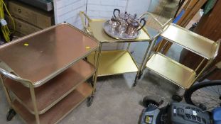 Three aluminium retro food serving trolleys together with a silver plated tea serving set