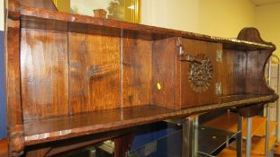 An oak wall mounted shelving unit by Jack Grimble, signed to the interior