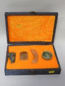 A cased set of four jade items