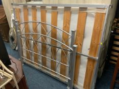 A modern metal double bed frame with mattress