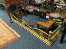 An Art Nouveau style brass fender together with a carved oak fender. (2)