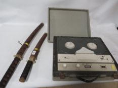 Two display samurai swords together with a reel to reel player