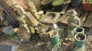 A large selection of concrete garden ornaments to include bird baths and pixie statues