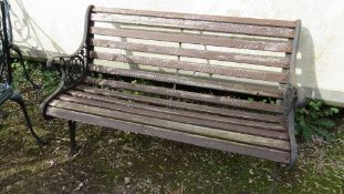 A cast iron and wooden garden bench