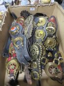 A tray of antique horse brasses many on straps