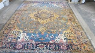 A large woollen patterned rug, blue and cream with fringe size 3.6m x 2.75m