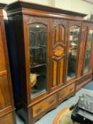 A large Edwardian carved triple mirrored wardrobe