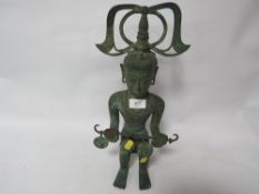 A sitting bronze style sculpture Tunah Toraja tribal art