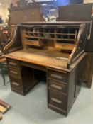 An antique oak roll top desk