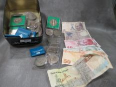 A tin of crown coins and world banknotes