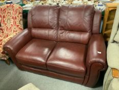A modern brown leather two seater settee
