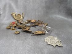A bag of military badges, buttons etc
