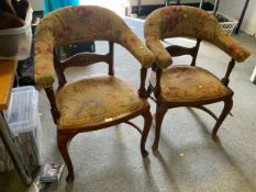 A pair of antique oak armchairs