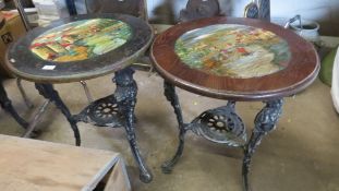 A pair of cast aluminium vintage style pub tables with painted tops