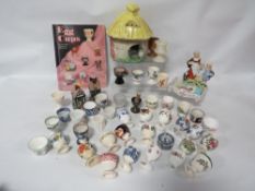 A tray of collectable egg cups, together with a collectors book to include George Jones, Royal