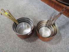 Two graduating sets of copper pans