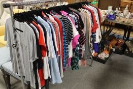 A rail of assorted ladies clothing, comprising mainly tops, to include examples by DKNY, M&S, Tog24,