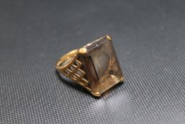 A HALLMARKED 9 CARAT GOLD SMOKEY QUARTZ RING, the stone set in a high gallery lattice style setting,