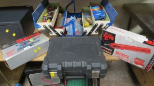 A toolbox and contents together with three boxed power tools