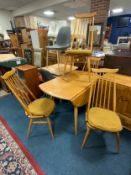 A Ercol ? Light drop-leaf table and four spindle back chairs