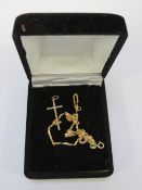 A 375 gold necklace approx weight 0.7g together with an unmarked yellow metal cross