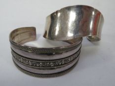 A 925 silver wavy bangle together with a silver QVC example approx combined weight 52g