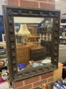 An antique carved oak rectangular mirror