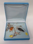 A box containing silver pendants, necklaces, earrings etc